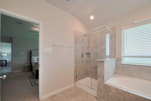 10005 Hermann Trce, Texas City, TX 77591 - full bath featuring ensuite bathroom, a bath, a shower stall, vaulted ceiling, and tile patterned flooring