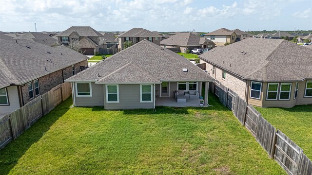 10005 Hermann Trce, Texas City, TX 77591 - rear view of house featuring a patio, a residential view, a fenced backyard, and a shingled roof