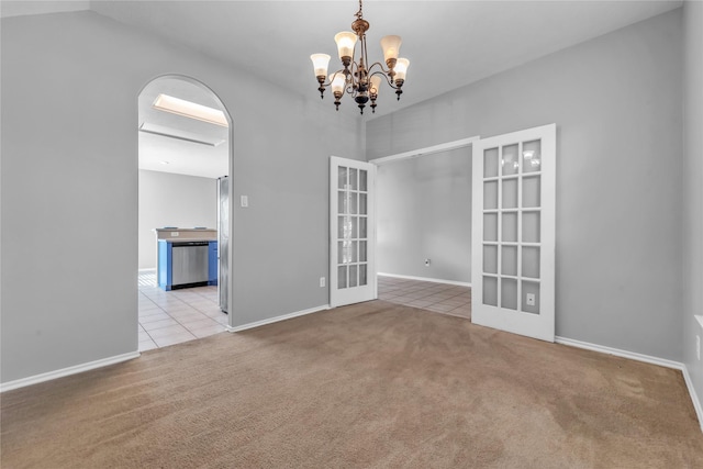 20607 Dademount Ct, Richmond, TX 77407 - carpeted empty room with tile patterned floors, a chandelier, and french doors
