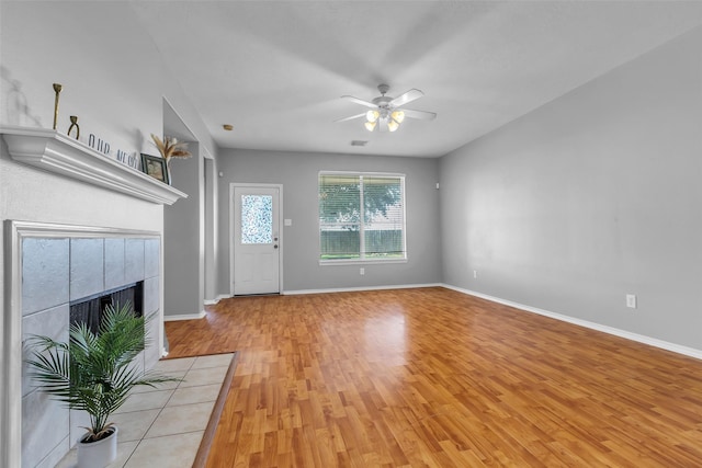 20607 Dademount Ct, Richmond, TX 77407 - unfurnished living room featuring ceiling fan, light wood finished floors, and a fireplace