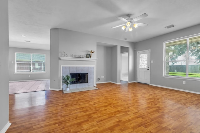 20607 Dademount Ct, Richmond, TX 77407 - unfurnished living room with wood finished floors, ceiling fan, and a fireplace