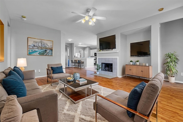 20607 Dademount Ct, Richmond, TX 77407 - living area featuring ceiling fan, wood finished floors, and a tiled fireplace