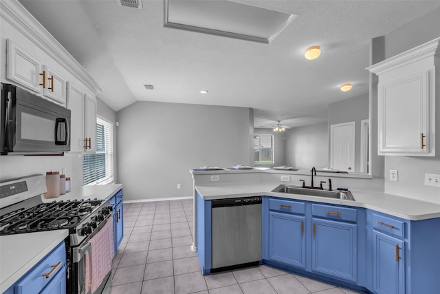 20607 Dademount Ct, Richmond, TX 77407 - kitchen featuring stainless steel appliances, blue cabinetry, white cabinetry, light countertops, and a peninsula
