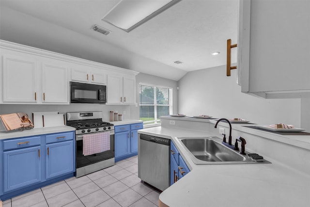 20607 Dademount Ct, Richmond, TX 77407 - kitchen with appliances with stainless steel finishes, blue cabinets, vaulted ceiling, white cabinets, and light countertops
