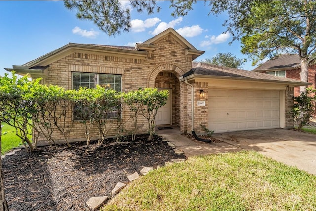 20607 Dademount Ct, Richmond, TX 77407 - view of front of home featuring driveway, an attached garage, and brick siding