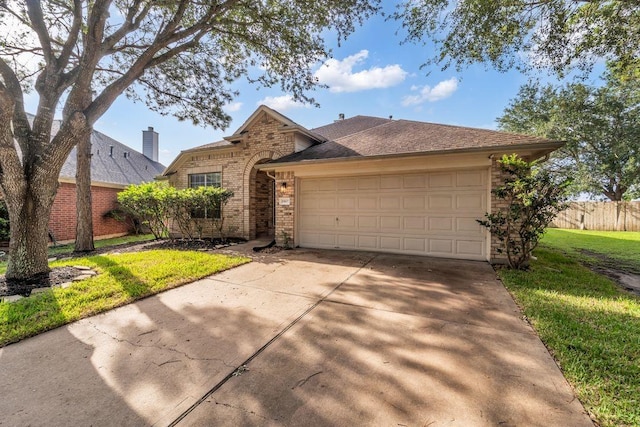 20607 Dademount Ct, Richmond, TX 77407 - view of front facade featuring driveway, brick siding, and an attached garage