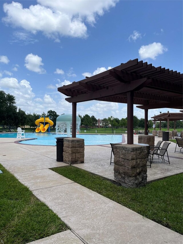 20607 Dademount Ct, Richmond, TX 77407 - view of patio / terrace featuring a water play area, a community pool, and a pergola