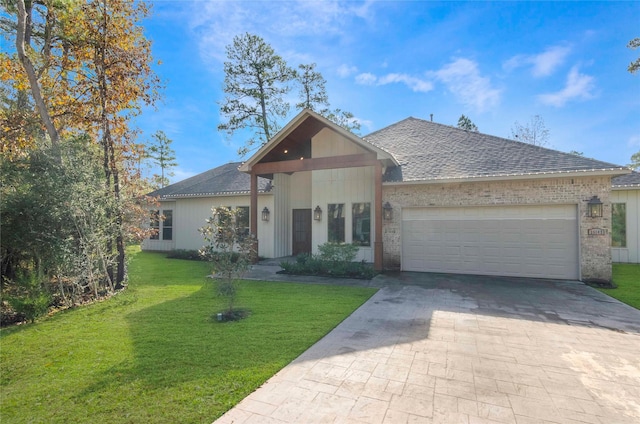 25142 W Tara Plantation Dr, Tomball, TX 77375 - view of front of house with a garage, roof with shingles, a front lawn, brick siding, and driveway