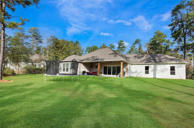 25142 W Tara Plantation Dr, Tomball, TX 77375 - back of house featuring a trampoline and a yard