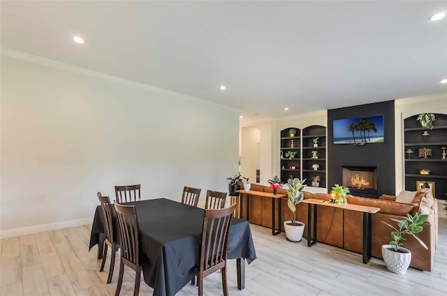 25142 W Tara Plantation Dr, Tomball, TX 77375 - dining area featuring recessed lighting, ornamental molding, light wood-style floors, built in shelves, and a large fireplace