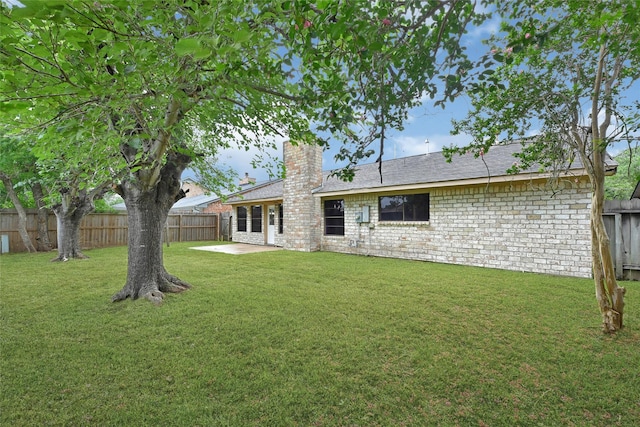 2730 Mesquite Dr, Sugar Land, TX 77479 - rear view of property with a chimney, a fenced backyard, a patio area, and a shingled roof