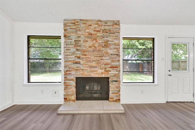 2730 Mesquite Dr, Sugar Land, TX 77479 - unfurnished living room featuring wood finished floors and a tiled fireplace
