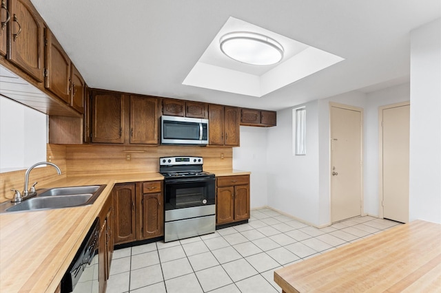 14555 Wunderlich Dr Unit 2602, Houston, TX 77069 - kitchen with appliances with stainless steel finishes, tasteful backsplash, light tile patterned floors, and a raised ceiling