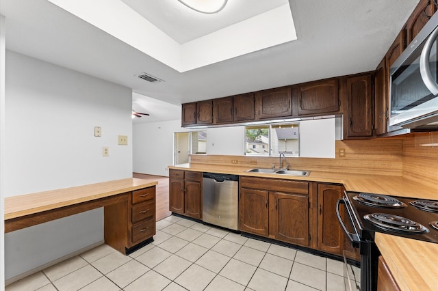 14555 Wunderlich Dr Unit 2602, Houston, TX 77069 - kitchen featuring appliances with stainless steel finishes, butcher block counters, light tile patterned flooring, an office area, and a peninsula