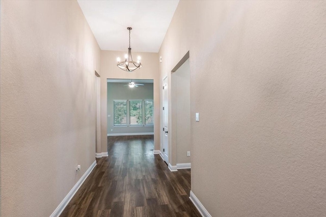 23 N Wheatleigh Dr, Tomball, TX 77375 - hallway with dark wood-style flooring and a chandelier