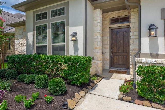 23 N Wheatleigh Dr, Tomball, TX 77375 - doorway to property featuring stone siding and stucco siding