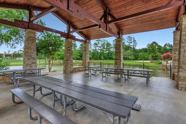 23 N Wheatleigh Dr, Tomball, TX 77375 - view of patio featuring view of wooded area and a water view