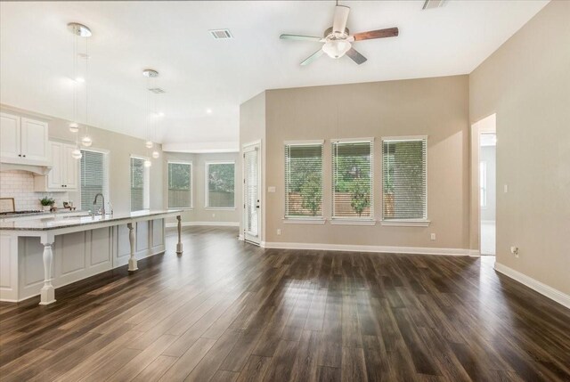 23 N Wheatleigh Dr, Tomball, TX 77375 - unfurnished living room featuring a ceiling fan and dark wood finished floors