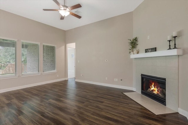 23 N Wheatleigh Dr, Tomball, TX 77375 - unfurnished living room featuring a ceiling fan, a tile fireplace, and dark wood-style flooring