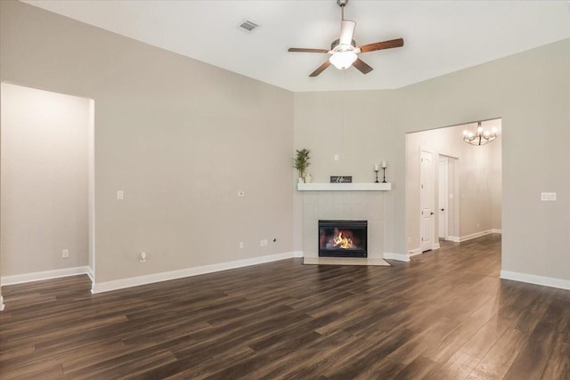 23 N Wheatleigh Dr, Tomball, TX 77375 - unfurnished living room with ceiling fan, dark wood finished floors, a fireplace, and a chandelier