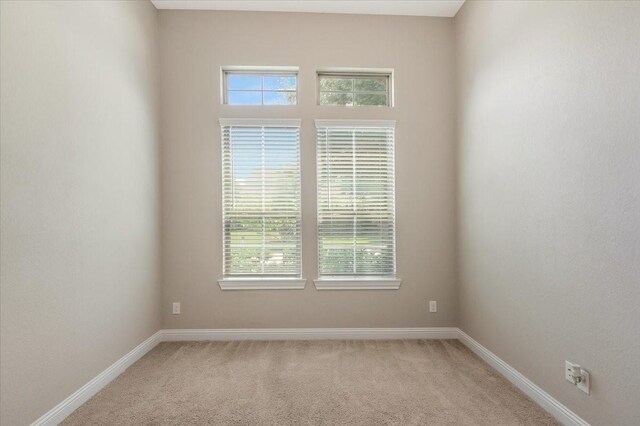 23 N Wheatleigh Dr, Tomball, TX 77375 - empty room featuring light colored carpet and baseboards