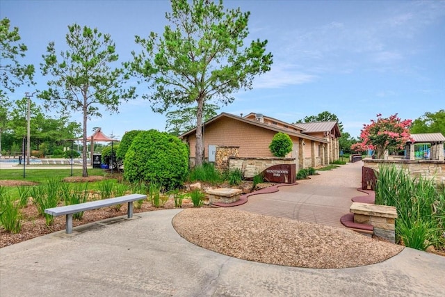 23 N Wheatleigh Dr, Tomball, TX 77375 - view of property exterior featuring stone siding