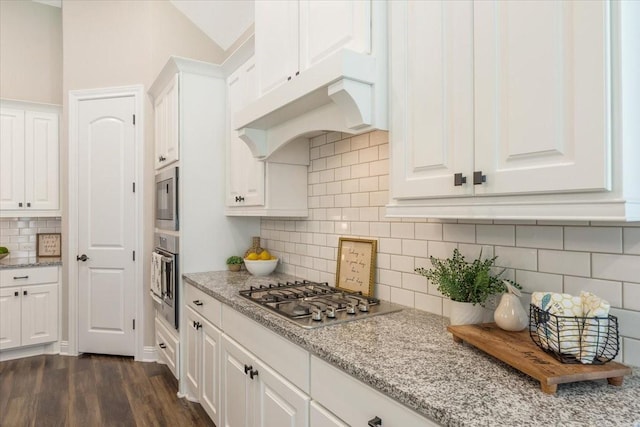 23 N Wheatleigh Dr, Tomball, TX 77375 - kitchen featuring stainless steel appliances, white cabinetry, tasteful backsplash, light stone countertops, and dark wood finished floors