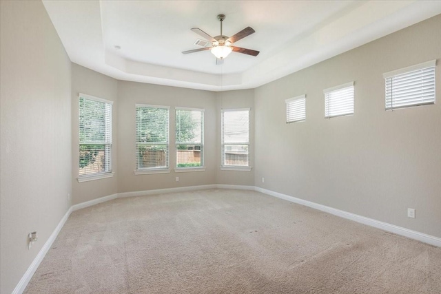 23 N Wheatleigh Dr, Tomball, TX 77375 - empty room featuring ceiling fan, light carpet, and a tray ceiling