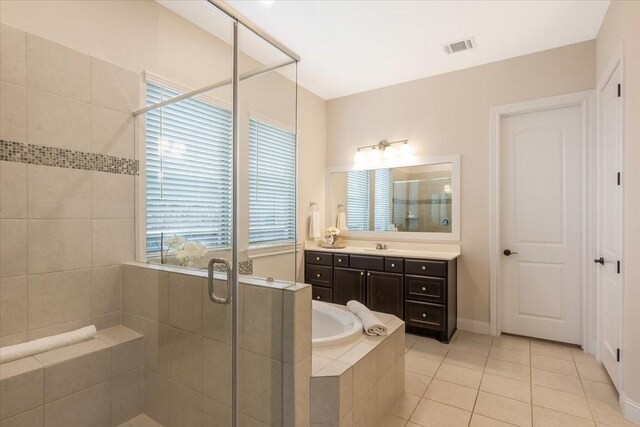 23 N Wheatleigh Dr, Tomball, TX 77375 - bathroom with a stall shower, vanity, tile patterned flooring, and a bath