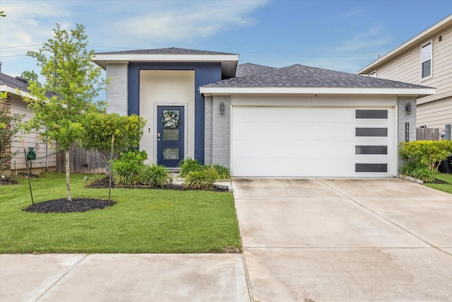 12717 Ermine St, Houston, TX 77047 - view of front facade with a garage, a shingled roof, driveway, and a front yard