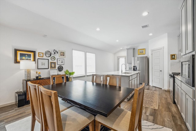 12717 Ermine St, Houston, TX 77047 - dining room featuring dark wood-type flooring, recessed lighting, and vaulted ceiling