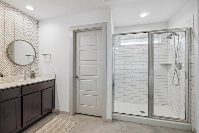12717 Ermine St, Houston, TX 77047 - bathroom featuring a stall shower, double vanity, tile patterned flooring, and recessed lighting