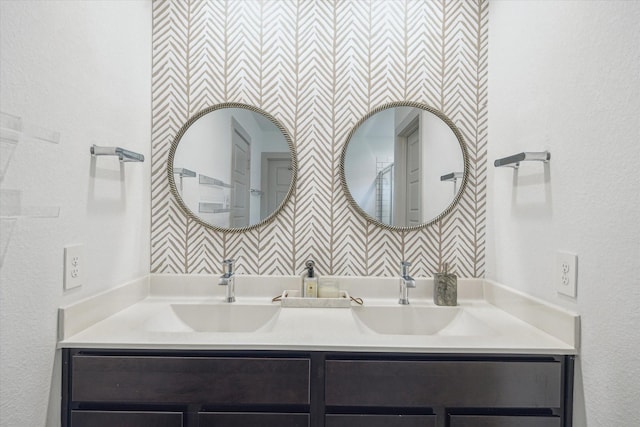 12717 Ermine St, Houston, TX 77047 - bathroom with double vanity and a textured wall