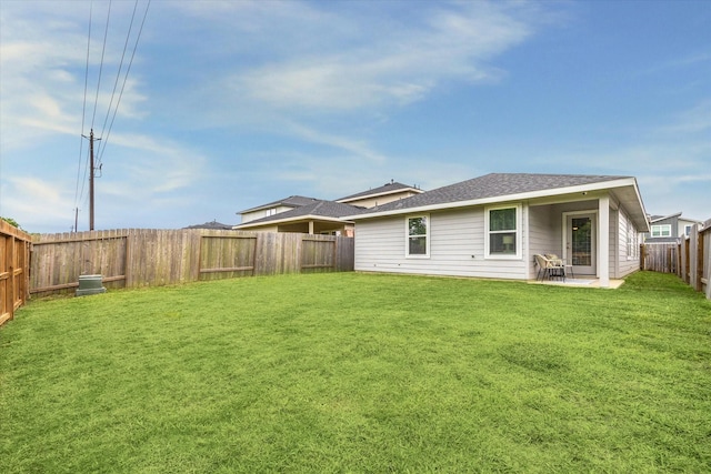 12717 Ermine St, Houston, TX 77047 - rear view of property featuring a fenced backyard, a patio area, and a shingled roof