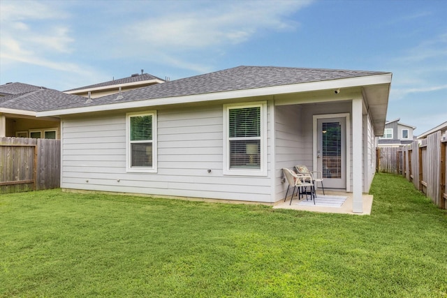 12717 Ermine St, Houston, TX 77047 - back of property with a fenced backyard, a shingled roof, and a patio