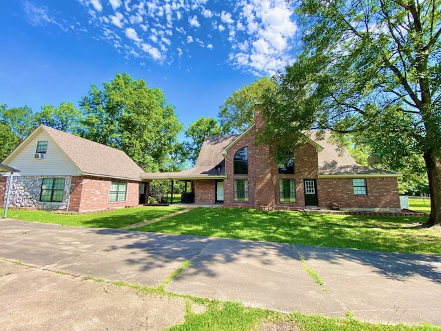 328 Mcguire Rd, Lufkin, TX 75901 - traditional home with brick siding, a chimney, a front lawn, and driveway