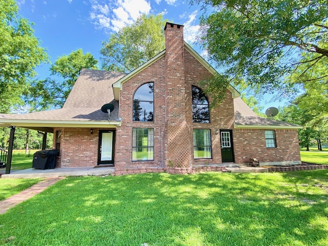 328 Mcguire Rd, Lufkin, TX 75901 - traditional-style house featuring a chimney, a front lawn, and brick siding