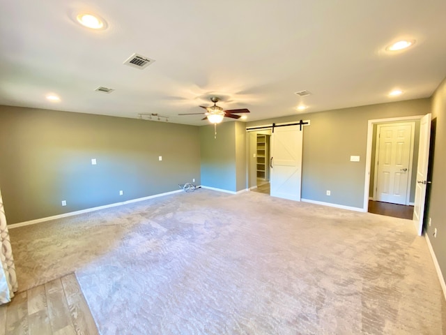 328 Mcguire Rd, Lufkin, TX 75901 - unfurnished bedroom featuring a barn door, carpet, recessed lighting, and a ceiling fan