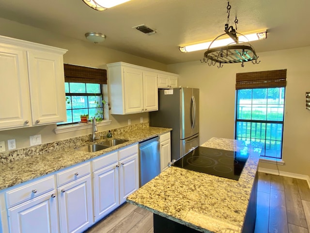 328 Mcguire Rd, Lufkin, TX 75901 - kitchen with appliances with stainless steel finishes, white cabinets, and a center island