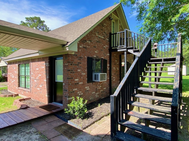 328 Mcguire Rd, Lufkin, TX 75901 - view of exterior entry with brick siding, roof with shingles, and cooling unit
