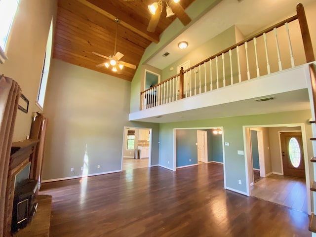 328 Mcguire Rd, Lufkin, TX 75901 - unfurnished living room featuring a ceiling fan, high vaulted ceiling, wood finished floors, a wood ceiling with exposed beams, and a wood stove
