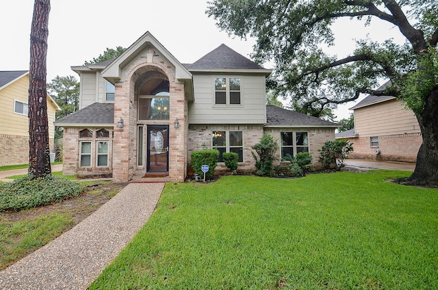 22410 Bucktrout Ln, Katy, TX 77449 - view of front of house with a front lawn, roof with shingles, and brick siding