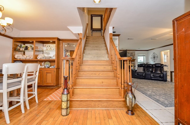 22410 Bucktrout Ln, Katy, TX 77449 - stairs with ornamental molding and hardwood / wood-style floors