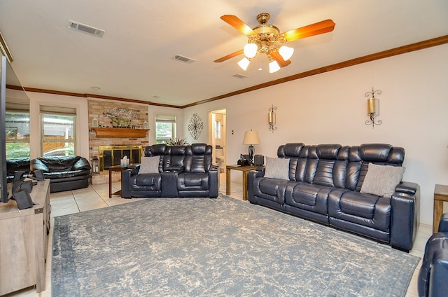 22410 Bucktrout Ln, Katy, TX 77449 - living room featuring ceiling fan, light tile patterned floors, a fireplace, and crown molding