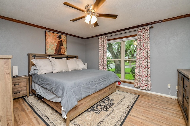22410 Bucktrout Ln, Katy, TX 77449 - bedroom featuring wood finished floors, ornamental molding, a textured ceiling, a ceiling fan, and a textured wall