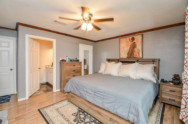 22410 Bucktrout Ln, Katy, TX 77449 - bedroom featuring light wood-style flooring, crown molding, ensuite bath, a textured ceiling, and a ceiling fan