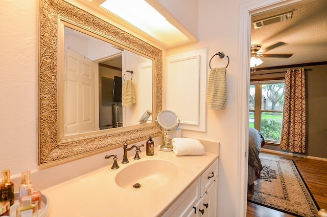 22410 Bucktrout Ln, Katy, TX 77449 - bathroom with vanity, ceiling fan, and wood finished floors