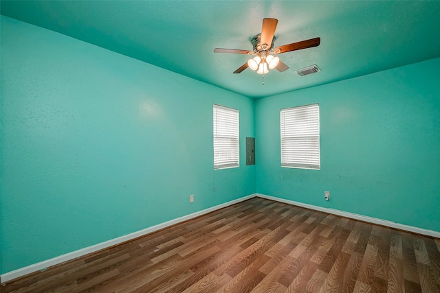3938 King St, Houston, TX 77026 - empty room with electric panel, dark wood-type flooring, and ceiling fan