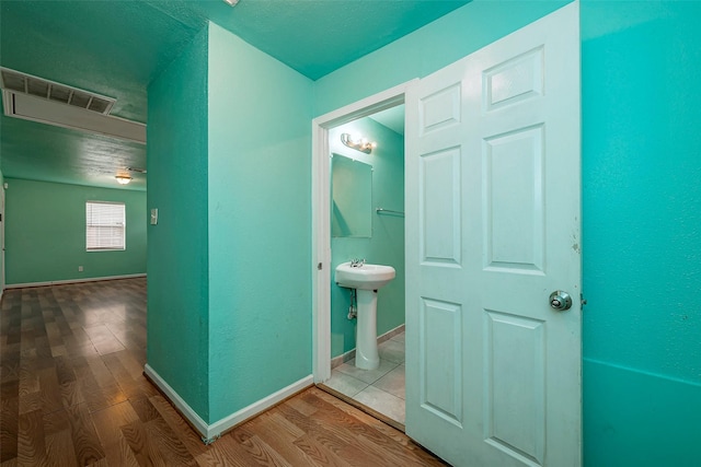 3938 King St, Houston, TX 77026 - corridor featuring wood finished floors and baseboards