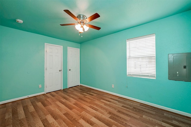 3938 King St, Houston, TX 77026 - unfurnished bedroom with electric panel, wood finished floors, and ceiling fan